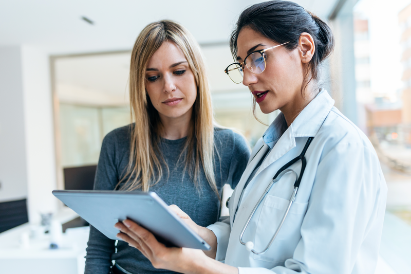 woman doctor consulting with woman patient