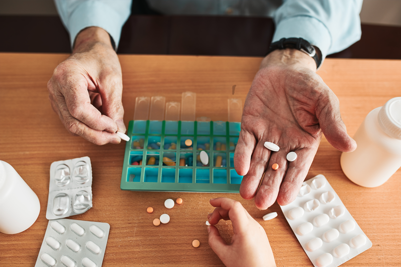 organizing pills into weekly organizer