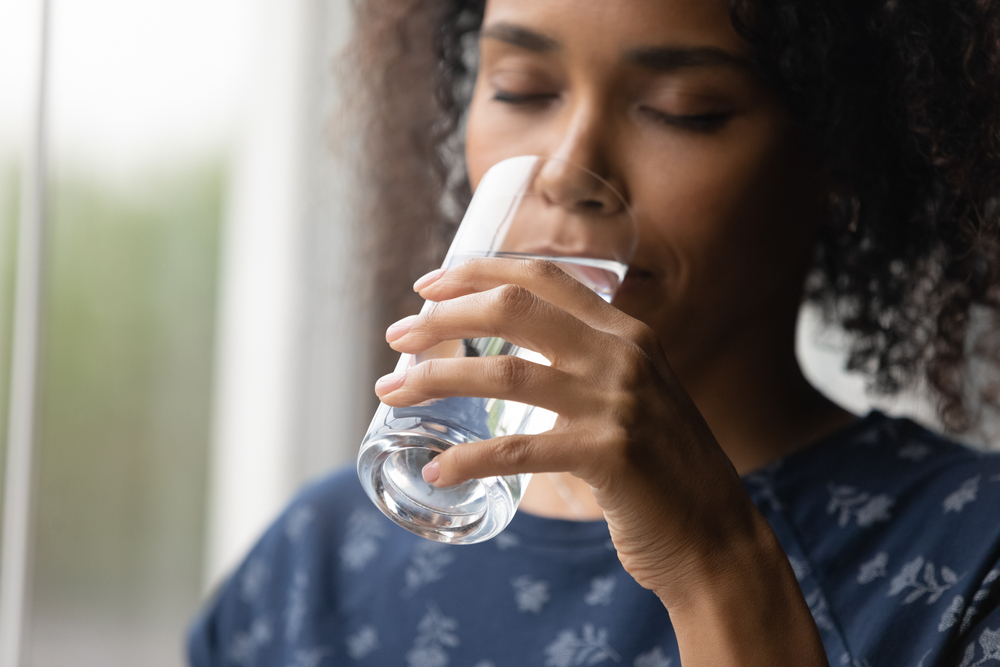 young woman drinking a glass of water