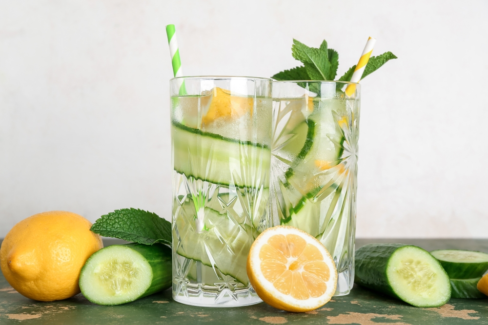 glasses of water with lemon, cucumber, and mint